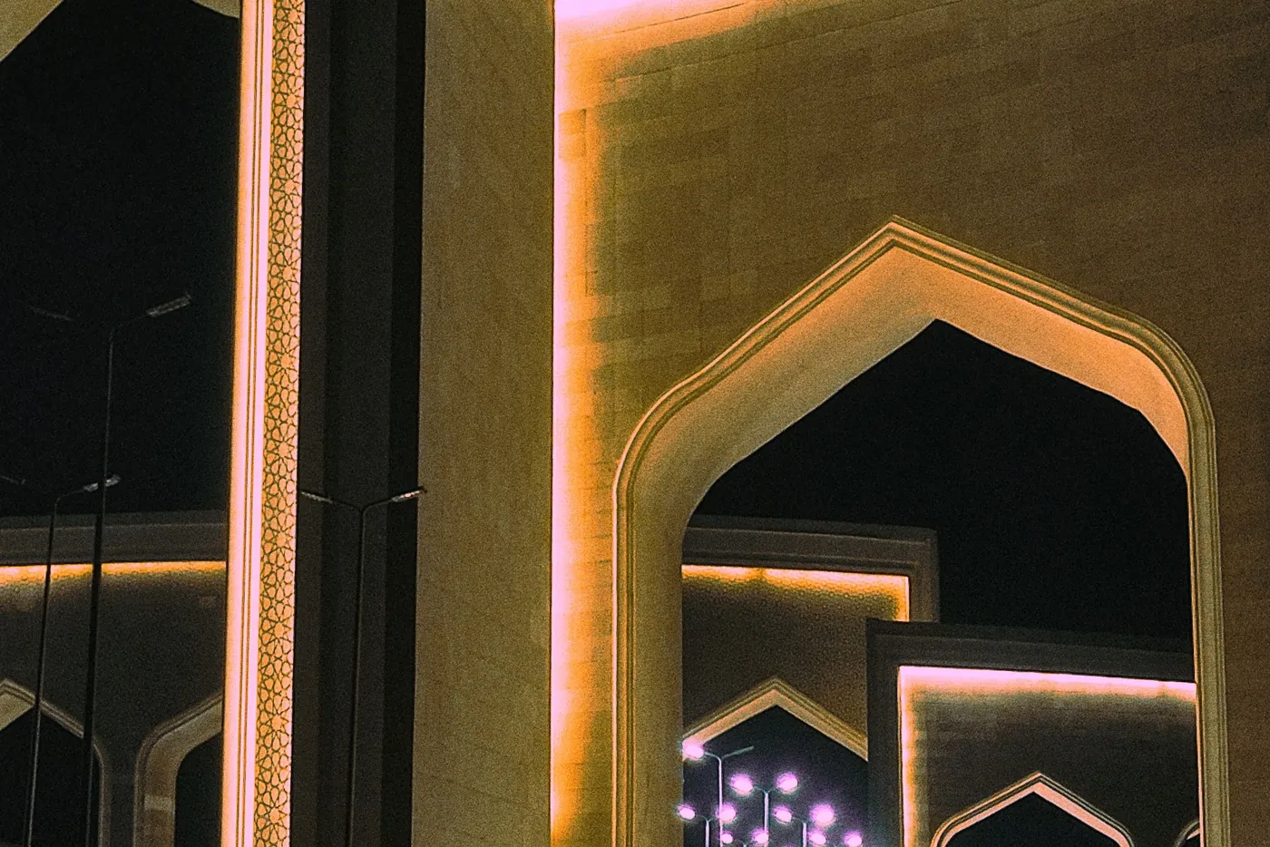 Illuminated arched gates at night in the New Administrative Capital